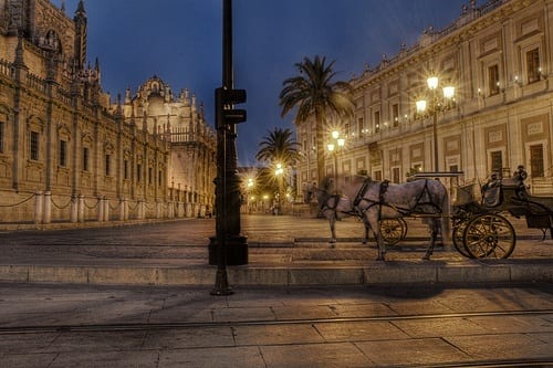 a horse and carriage going down a street