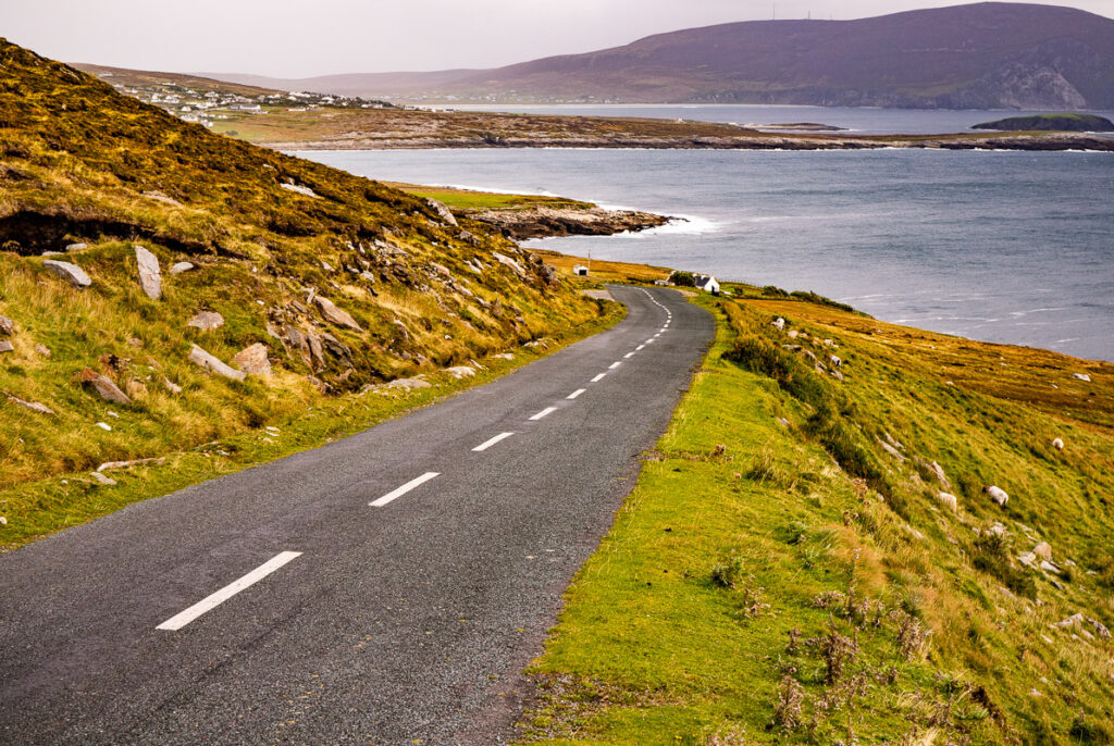 Coastal road sloping downhill towards the ocean