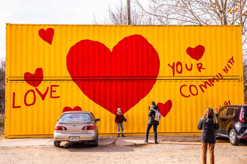 people standing in front of a mural