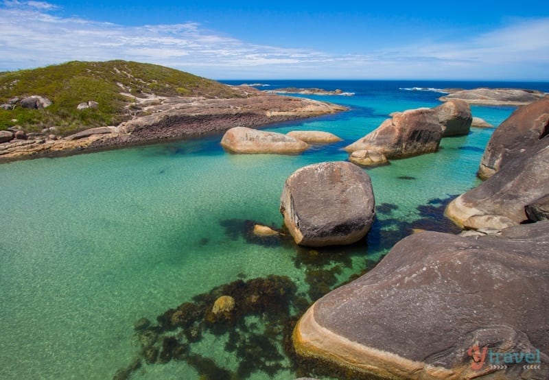 rocks in green ocean water