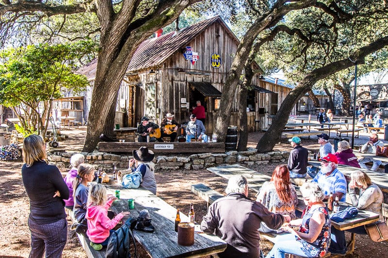 people outside on picnic tables