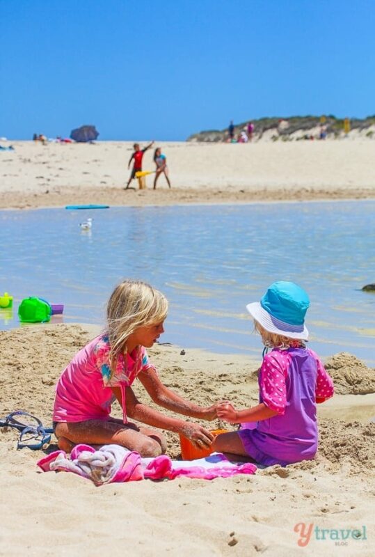 savannah and kalyra playing on prevelly beach wa