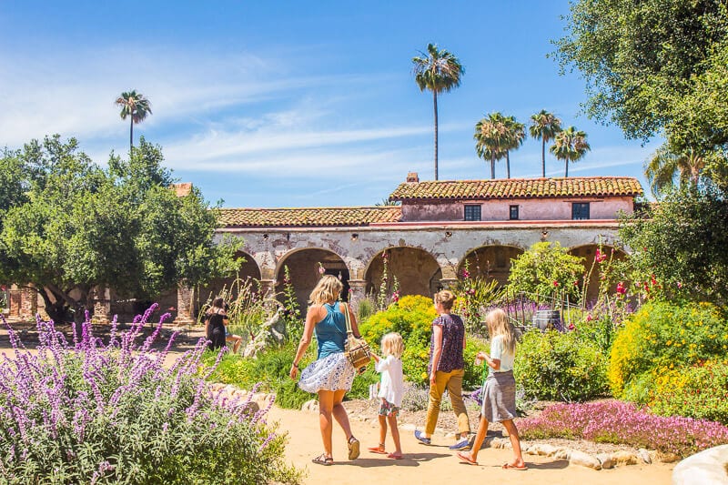 people walking through a garden