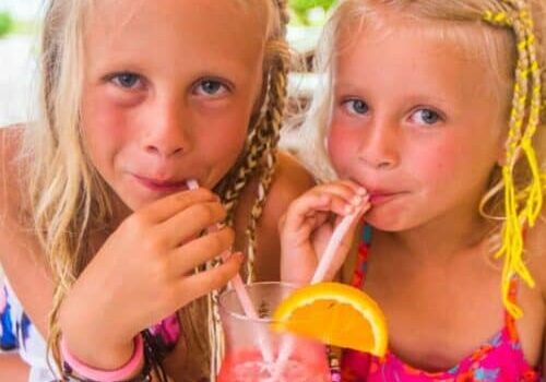 two girls drinking fruit punch