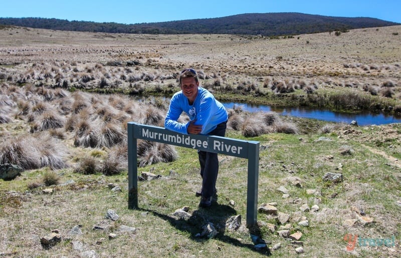 man leaning on a sign