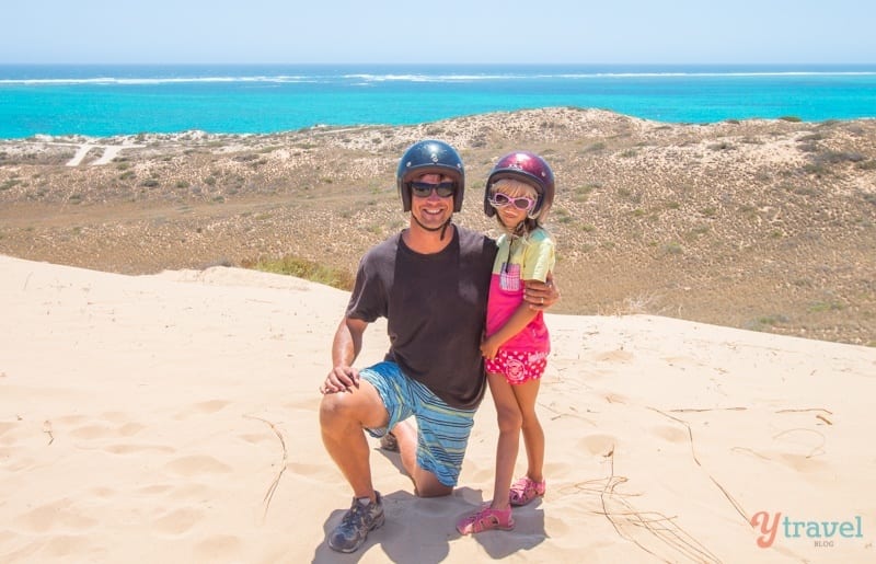 craig and savannah posing to camera on edge of cliff