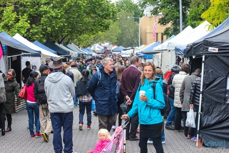 woman standing with stroller in crowded market