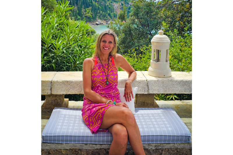 caz sitting on bench smiling in kardamyli